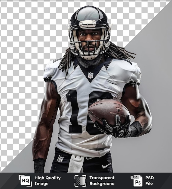 transparent psd picture american football player wearing helmet posing with ball wearing black pants and gloves and holding a brown football with a black face and arm visible in the background