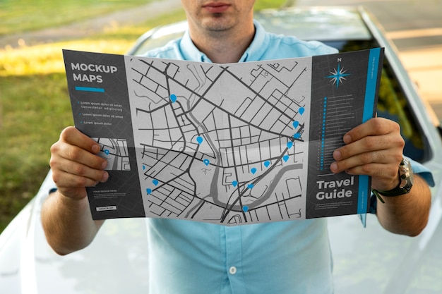 Travel guide map held by person on vacation