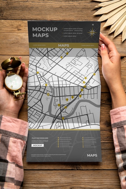 Travel guide map held by person on vacation