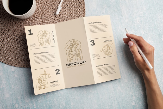 Trifold brochure mock-up held by person in hand