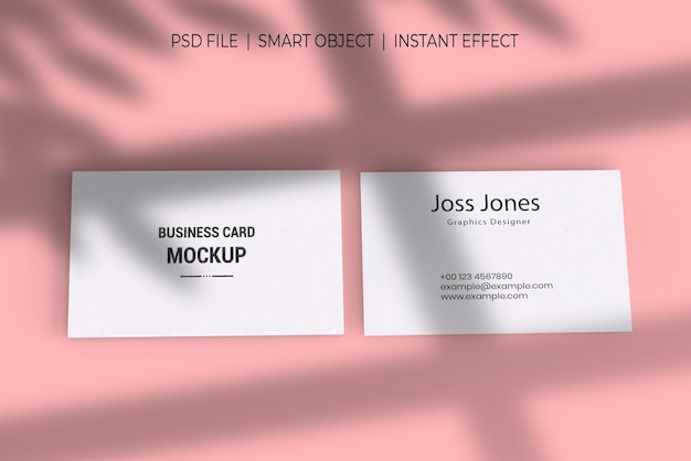 Two business cards on a pink background