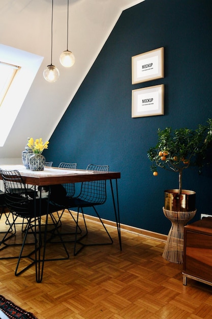 Two small picture frames in a living room under the roof with blue walls