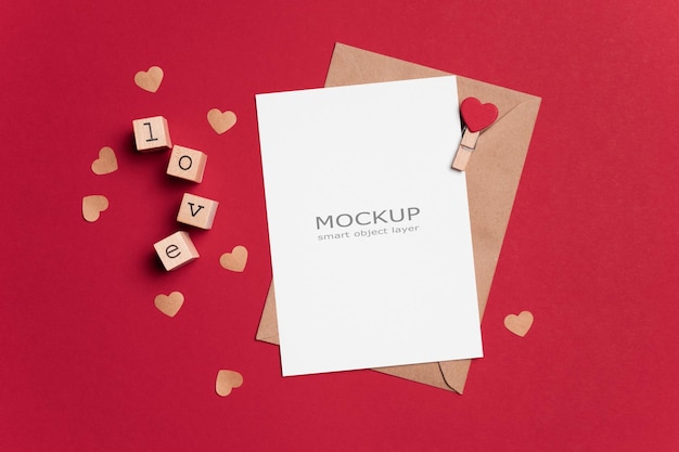 Valentines day flat lay with blank paper card mockup on red