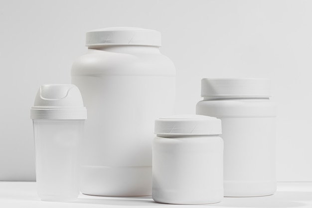 Various white containers with protein powder