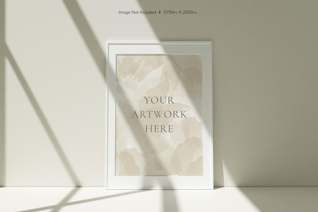 Vertical white photo frames mockup on the floor leaning against the room wall with shadow