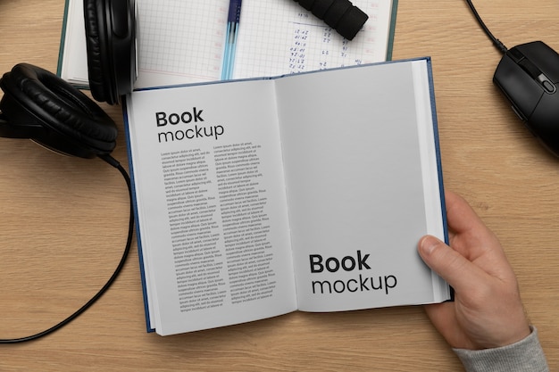 View of hand holding book mock-up