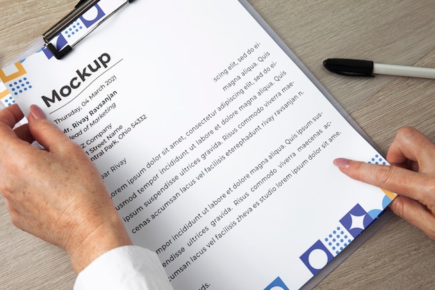 View of human hands holding paper document mock-up