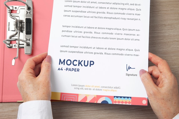 View of human hands holding paper document mock-up