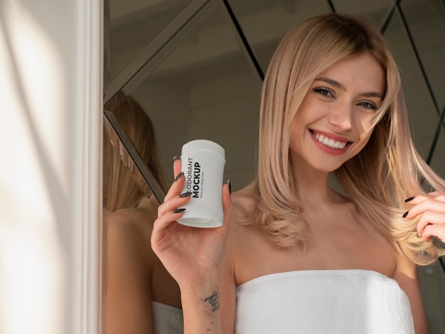 View of woman with roll on deodorant after shower