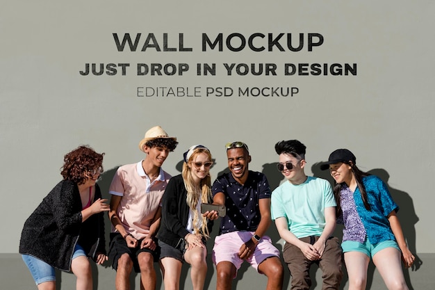 Wall mockup psd, teen friends watching a video on a smartphone