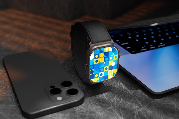 PSD a watch with a blue square on it sits next to a laptop