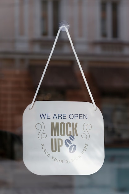 We are open sign mock-up hanging in the window