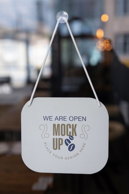 We are open sign mock-up hanging in the window