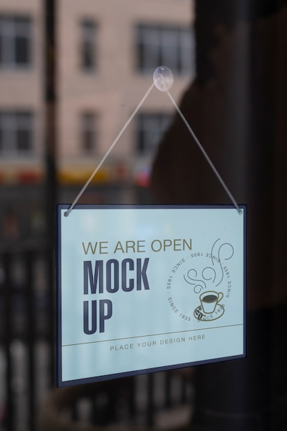 We are open sign mock-up hanging in the window