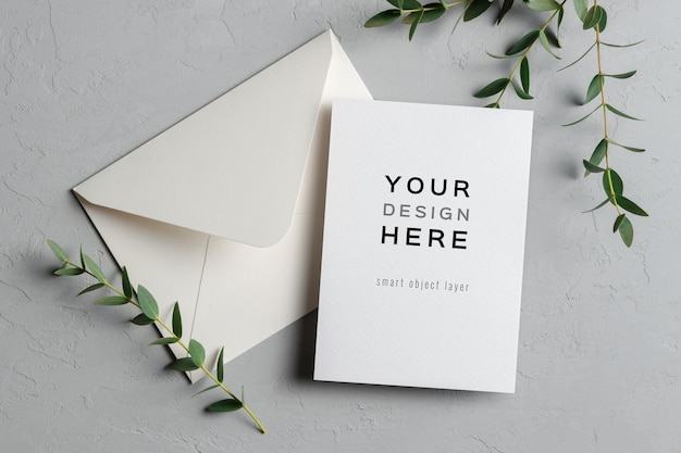 Wedding invitation card mockup with eucalyptus twigs and envelope