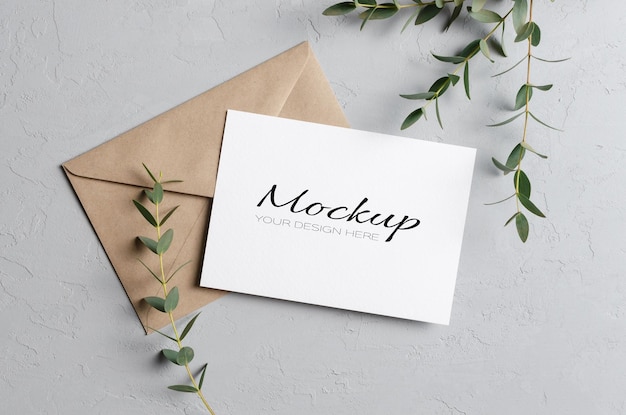 Wedding invitation card mockup with eucalyptus twigs and envelope