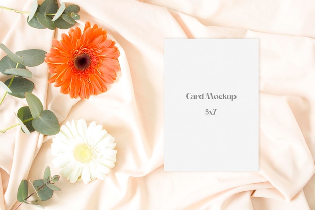 PSD wedding invitation mockup with gerbera and nude fabric