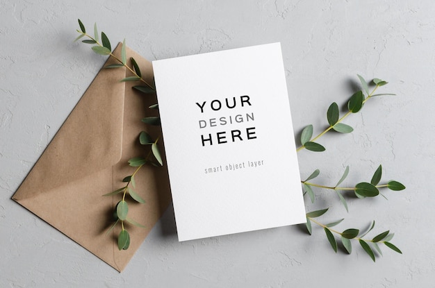 Wedding invitation stationery card mockup with eucalyptus twigs and envelope