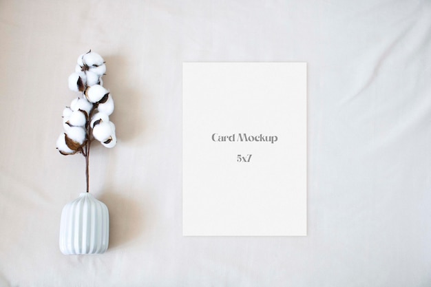 PSD wedding mockup card with cotton leaf on the beige background