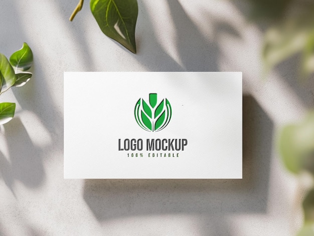 a white business card with a green logo on it