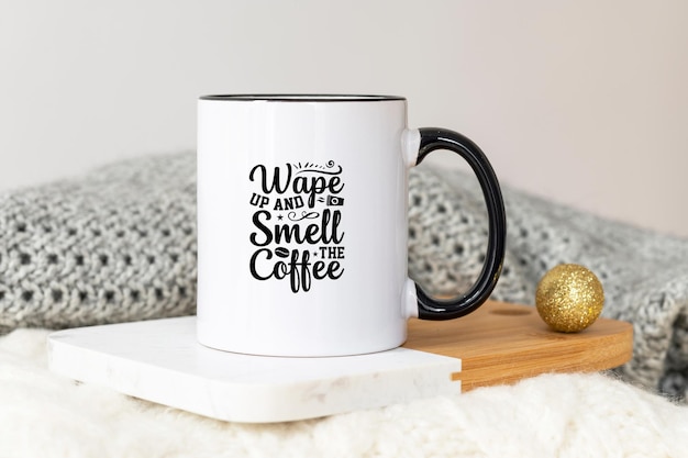 White ceramic coffee cup with black handle mockup on cozy winter background with warm sweaters and copy space for your design Standard 11 oz mug with golden handle for imprint branding and souvenirs