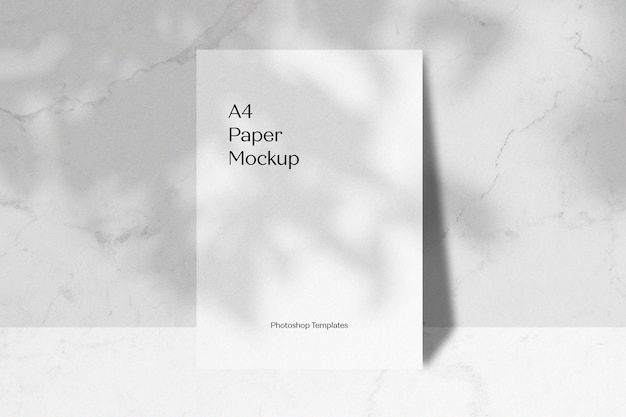 White Paper Mockup Leaning on Wall with Leaves Shadow