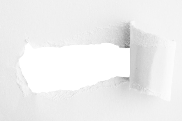 White thick paper torn in the middle with an empty hole And an empty background behind