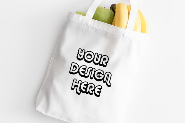 White tote bag mockup with fruit on a white table