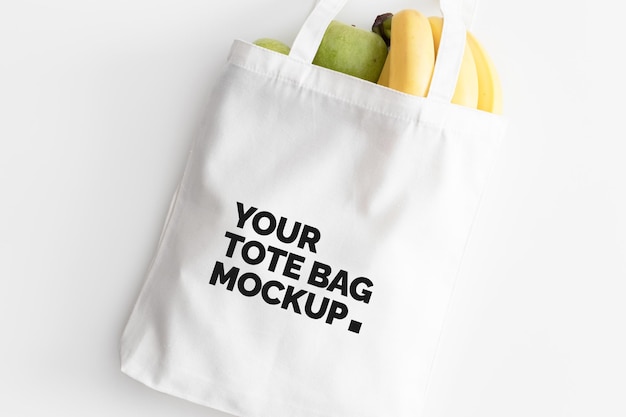 White tote bag mockup with fruit on a white table