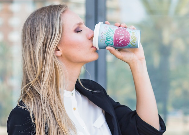 Woman drinking coffee from plastic cup