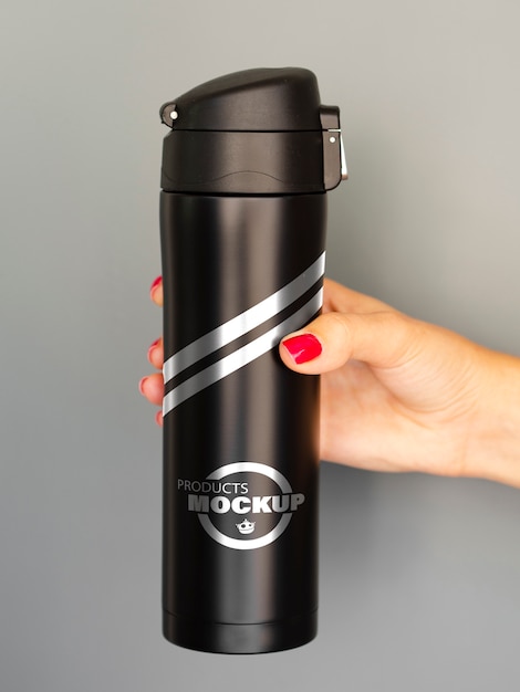 Woman holding a black thermos mock-up