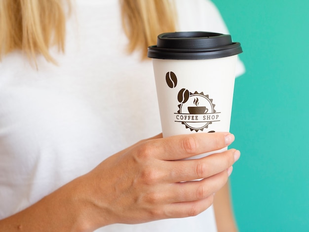 Woman holding a coffee paper cup mock-up