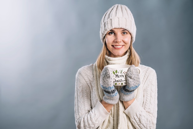 PSD woman holding cup mockup with christmas concept