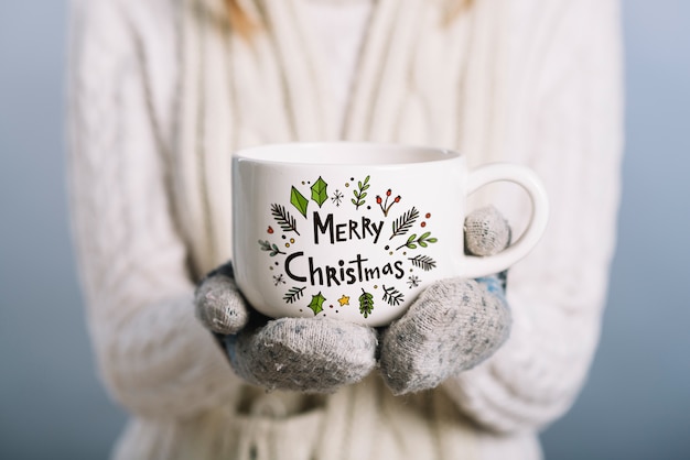 PSD woman holding cup mockup with christmas concept