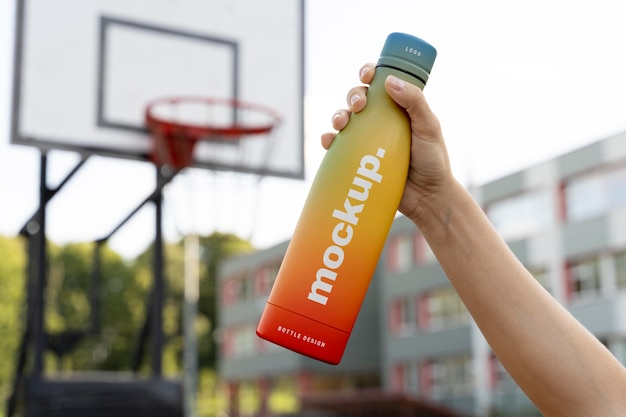 Woman holding a mock-up water bottle