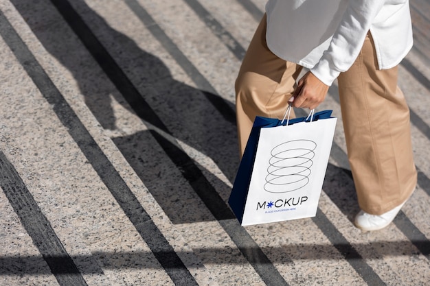 Woman holding shopping bag outdoors on the street