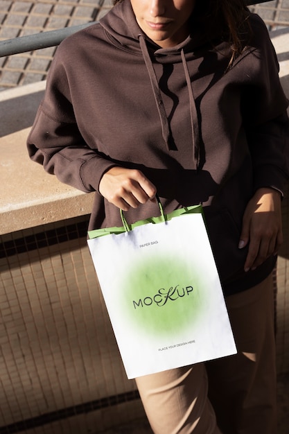 PSD woman holding shopping bag outdoors on the street