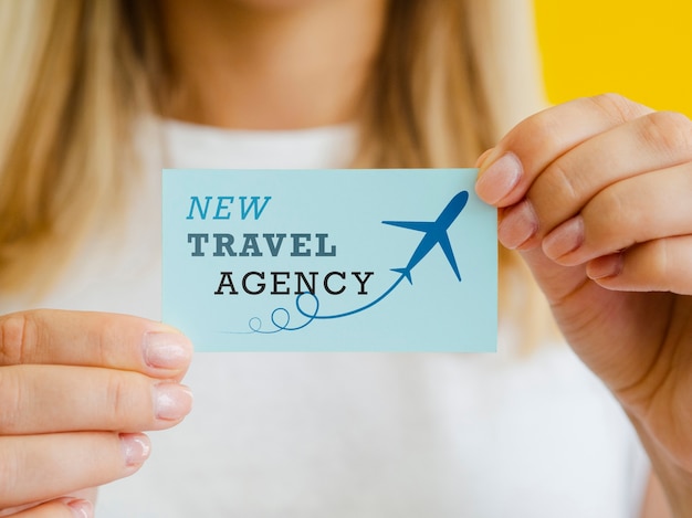 Woman holding a travel agency card