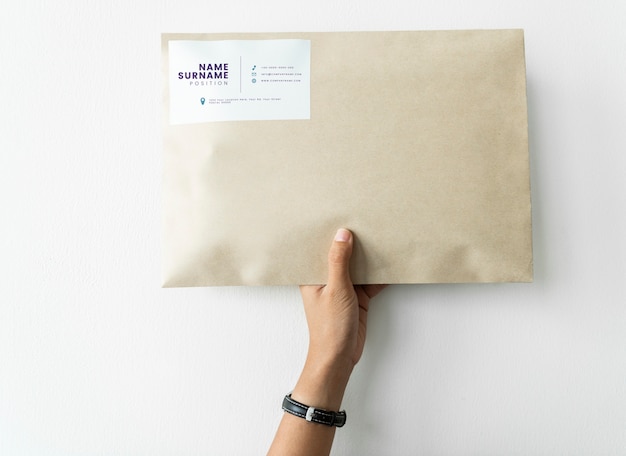 PSD woman holding up a package mockup