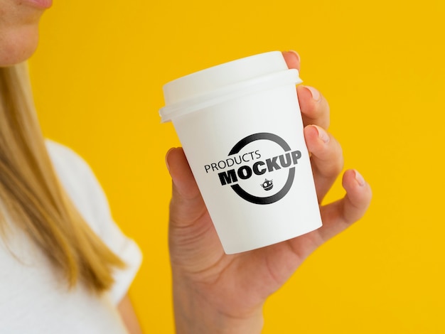 Woman holding a white coffee cup mock-up