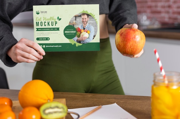 Woman at home with oranges and kiwi