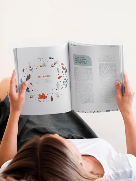 Woman lain down and reading a magazine mock up