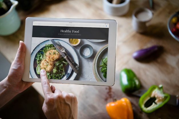 PSD woman pointing at a screen with heathy foods