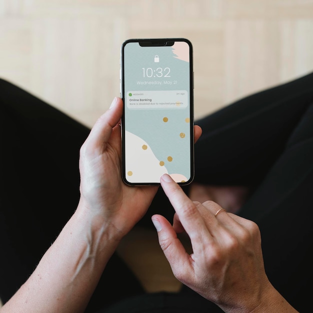 Woman reading a message from the bank on a mobile phone mockup