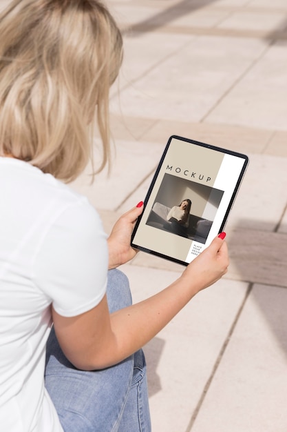 PSD woman on street reading book on tablet