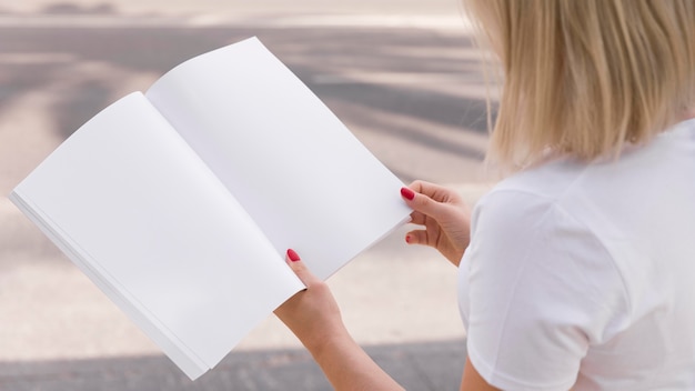 Woman on street reading book