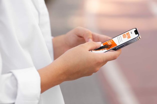 Woman using mock-up smartphone outdoors