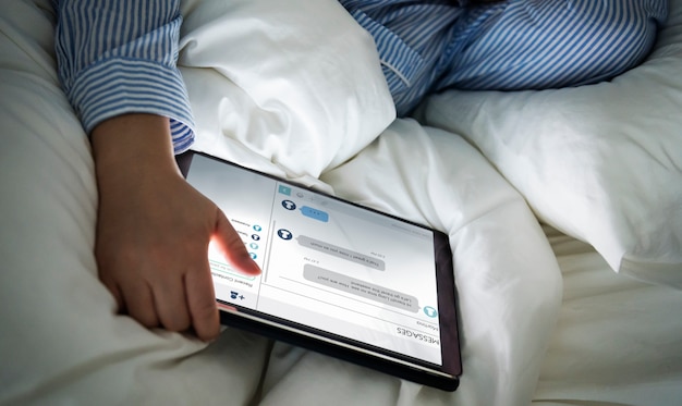 PSD a woman using a tablet in bed