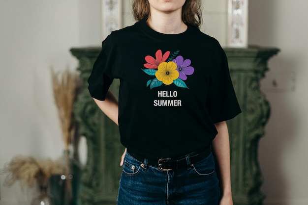 a woman wears a black t shirt with flowers on it