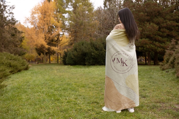 Woman with blanket in nature